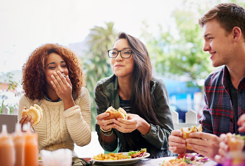 People laughing while eating